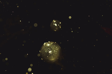 Wall Mural - golden particles abstract dark background