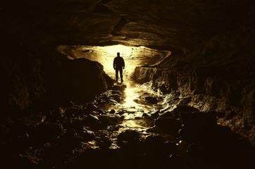 Wall Mural - dark cave with man silhouette