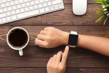 Aufkleber - hand using smartwatch on desk top view