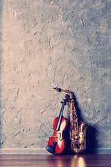 Sticker - Violin and saxophone on gray wall background