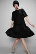 © EVGENY FREEONE - Brunette woman in black dress