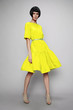 © EVGENY FREEONE - Brunette woman in yellow dress