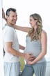 © WavebreakmediaMicro - Man holding pregnant womans stomach