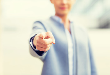 Poster - young smiling businesswoman over office building