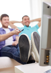 Wall Mural - close up of happy male friends watching tv at home