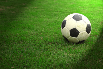  Football on green grass with spot light