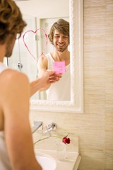 Boyfriend discovering a love message on the mirror
