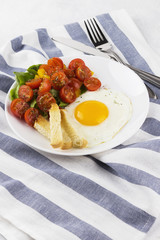 breakfast: fried eggs with tomatoes and pepper on a white backgr