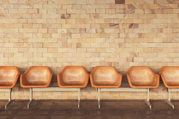 Old chairs with yellow brick wall background.