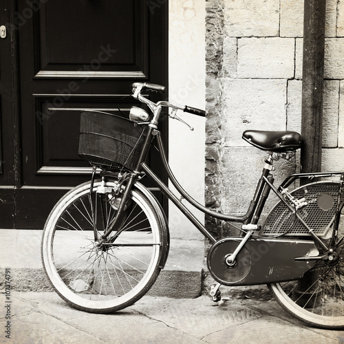 Fototapeta Old photo of bicycle with wicker basket, Italy