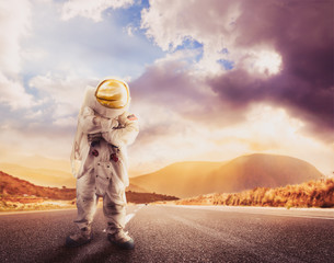 Wall Mural - Astronaut standing on a road