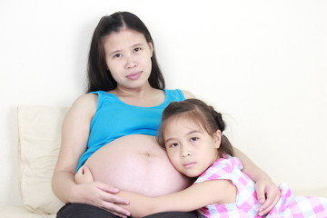 Wall Mural - Beautiful pregnant woman and her daughter