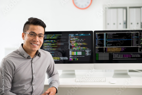 Fotografie, Obraz Portrait of smiling young Vietnamese software engineer