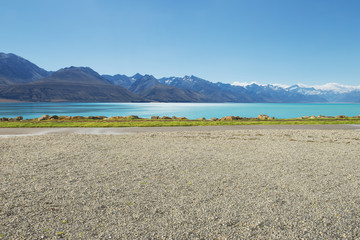 Wall Mural - empty rural road near lake and snow mountain in new zealand