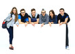 © ASDF - Full length portrait of confident college students displaying blank billboard against white background