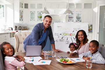 Wall Mural - Domestic meeting in the kitchen, family looking to camera