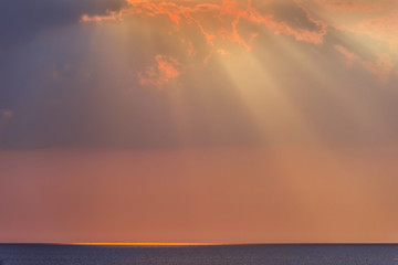 Rays of evening sun over sea