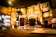© littleny - Defocused bar blur with 2 mugs of beer in focus