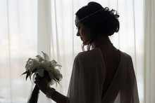 Silhouette Of Beautiful Bride Standing Near Window