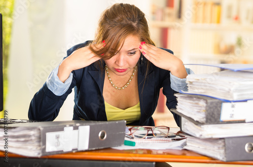 Business Woman Sitting By Desk Paper Files Spread Out Elbows On
