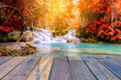 Vintage style wooden floor perspective with beautiful autumn waterfall.