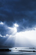Dark dramatic sky with clouds and sunlight rays