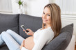 © and.one - Beautiful pregnant woman relaxing at home