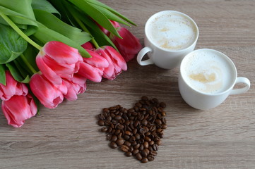 two cups of cappuccino with flowers