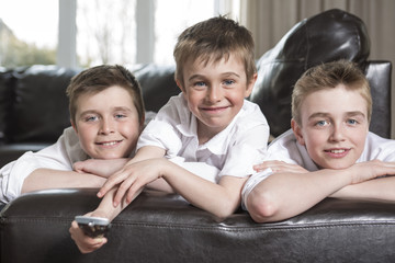 brothers hugging and playing on the sofa