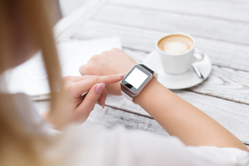 Wall Mural - Female setting up her new smart watch.