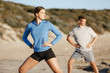 © Sergey Nivens - Young couple on beach training together