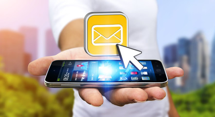 Young man using modern mobile phone to send message