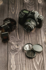 Photo camera on wooden rustic background