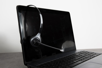 Laptop computer with headset isolated on white