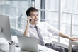 © Blue Jean Images - Businessman talking on the phone in office
