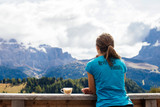 Fototapeta Londyn - Girl with inspirational t-shirt drinking coffee in the high mountains