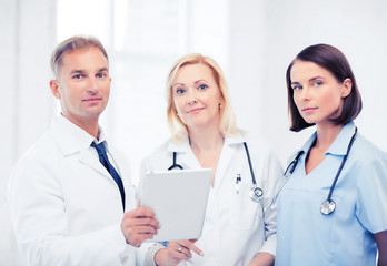 Wall Mural - doctors looking at tablet pc