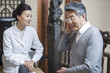 © Blue Jean Images - Female Chinese doctor talking with patient