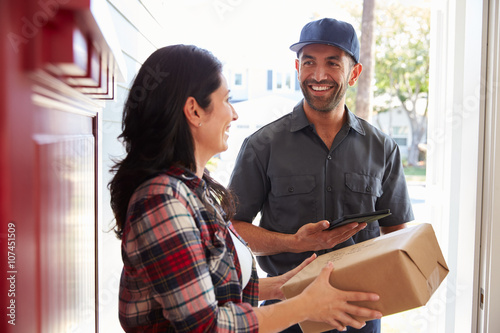 Stampe Woman Receiving Package From Courier At Home