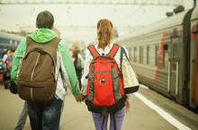 Caucasian Couple Holding Hands On Train Station Platform