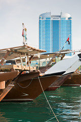 Canvas Print - Abu Dhabi buildings skyline with old fishing boats