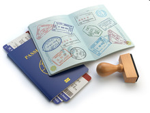 Opened Passport With Visa Stamps And Airline Boading Pass Ticket