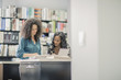 © John Fedele/Blend Images - Businesswomen working together in office