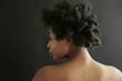 © Peathegee Inc/Blend Images - Close up of black woman looking over shoulder