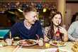 © Aleksander Rubtsov/Blend Images - Caucasian couple laughing in restaurant