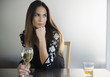 © JGI/Jamie Grill/Blend Images - Lonely Caucasian woman drinking white wine in bar