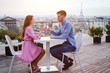© Song_about_summer - couple drinking champagne in luxury rooftop restaurant in Paris with panoramic view of Eiffel Tower