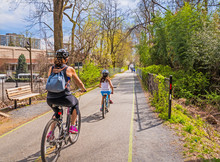 Family Ride Bikes On Urban Bike Path In The City