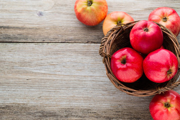 Wall Mural - Ripe red apples on wooden background.