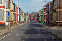 A Street Of Boarded Up Derelict Houses Awaiting Regeneration In Liverpool UK